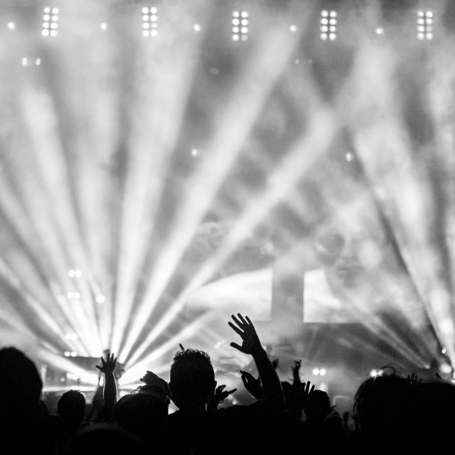 Show lights raking over a standing crowd