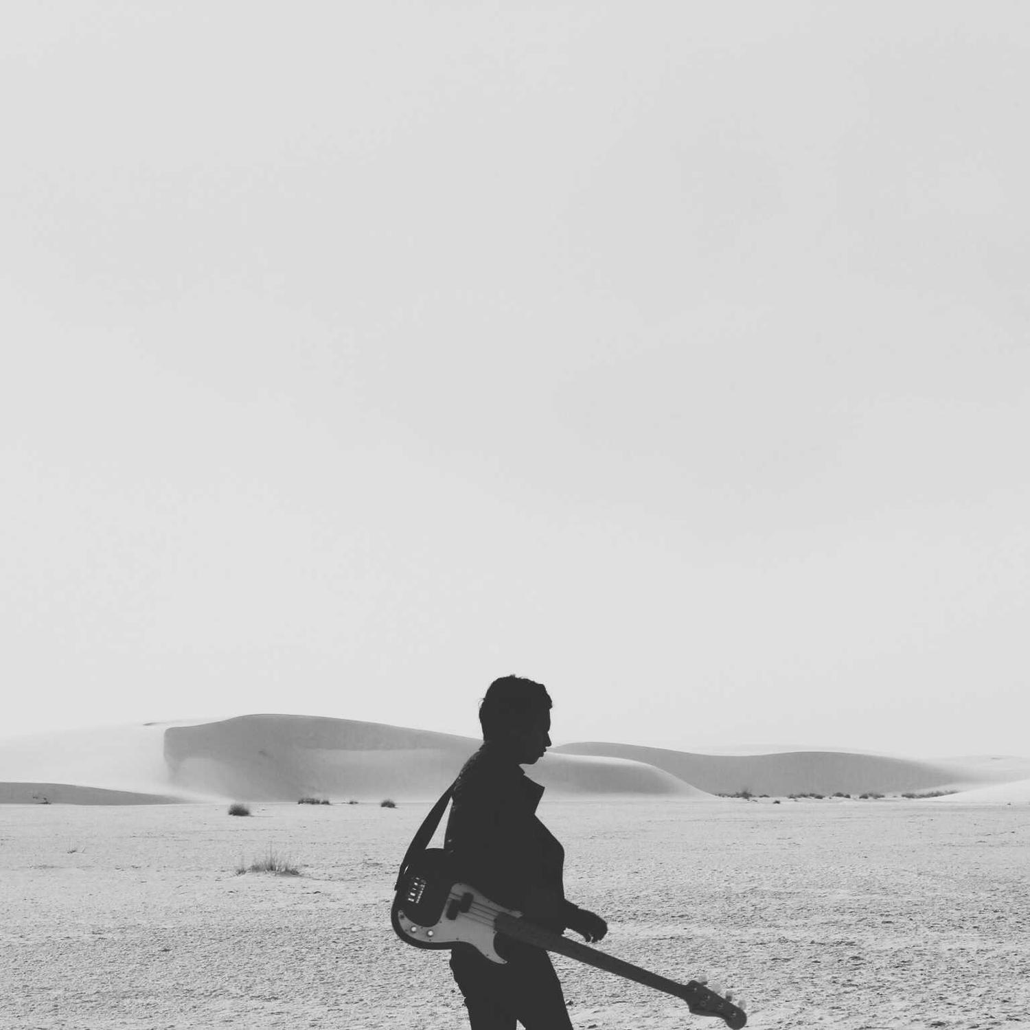 Silhouette with guitar on an empty beach