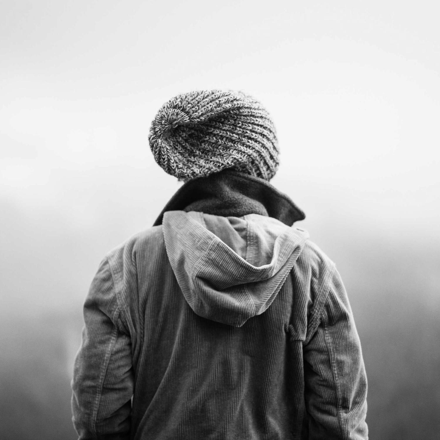 Back view, jacket slung over one shoulder
