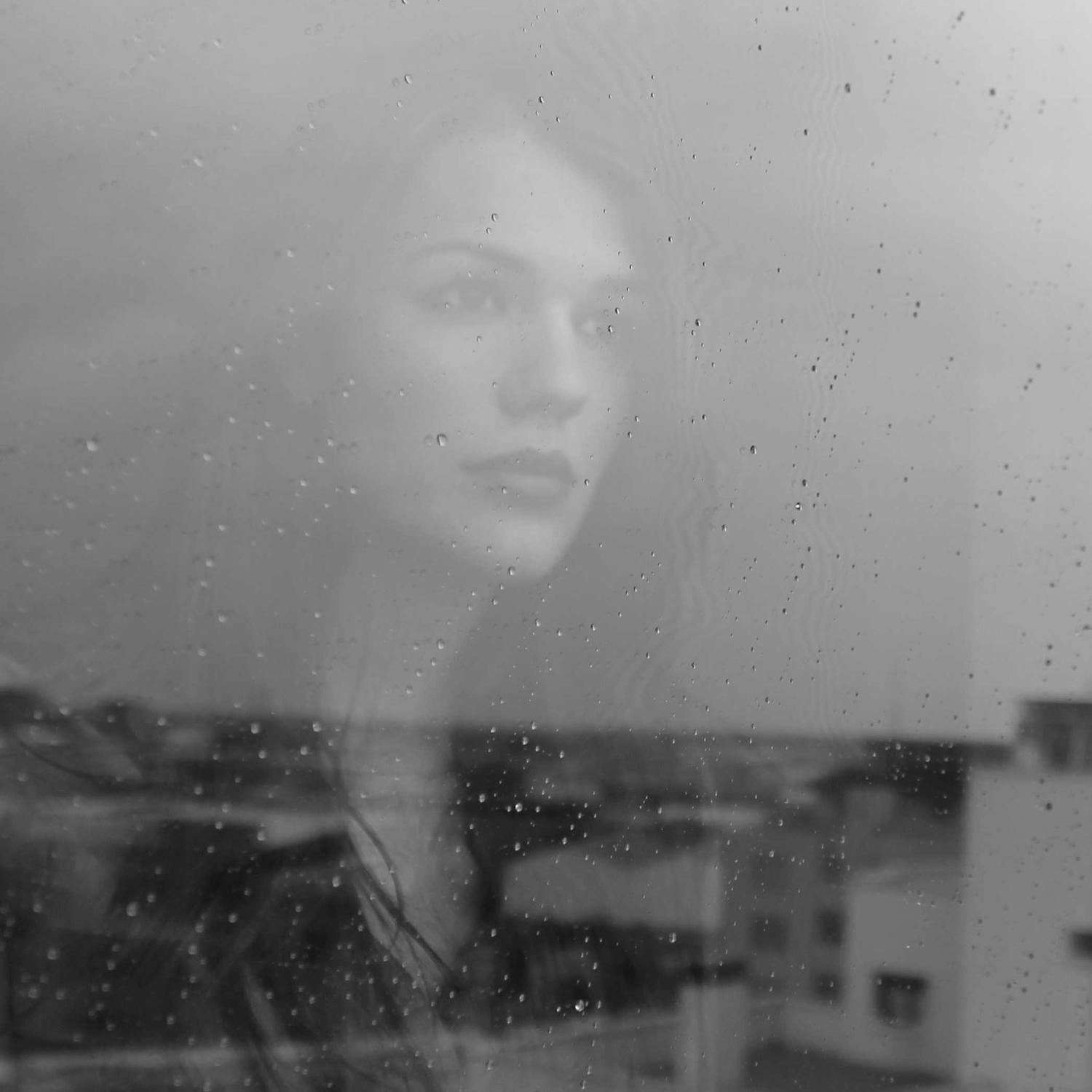 Double-exposure portrait through glass